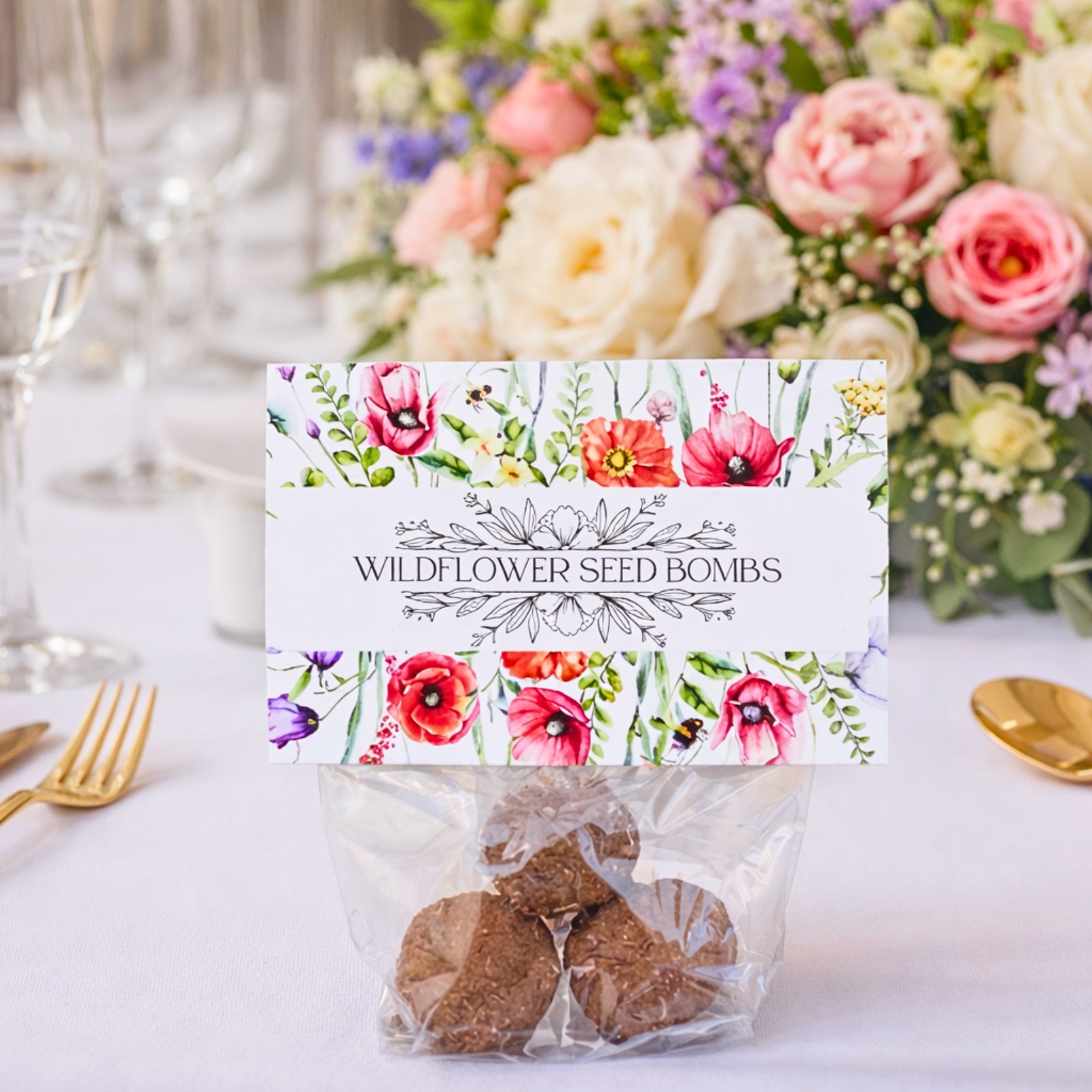 Wildflower seed bomb wedding favour presented with floral card and clear plant-based bag